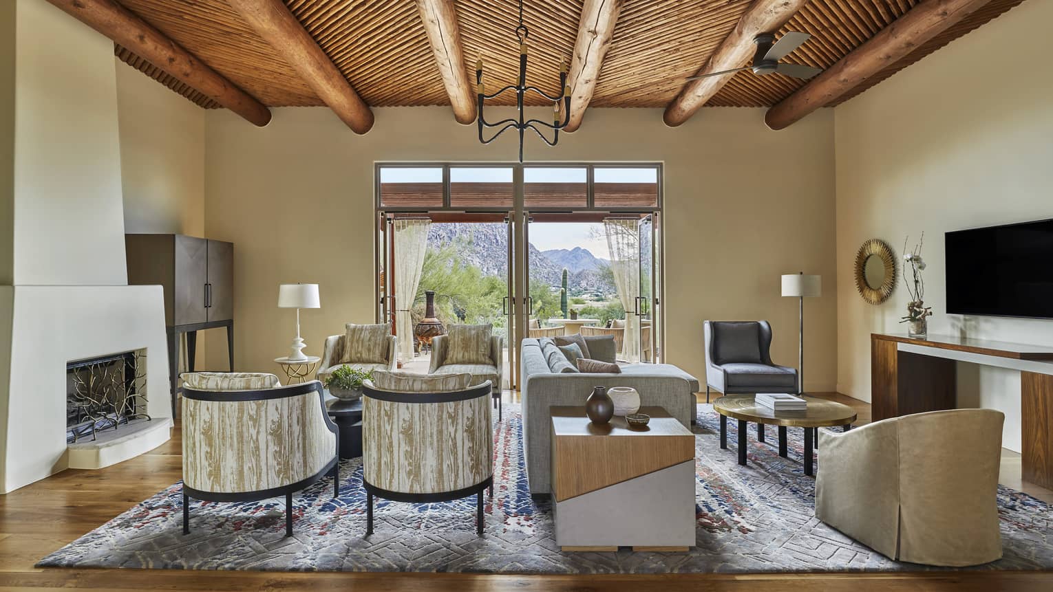 Jerome Suite modern clay fireplace and seating area with sofa, wood-grain patterned armchairs 