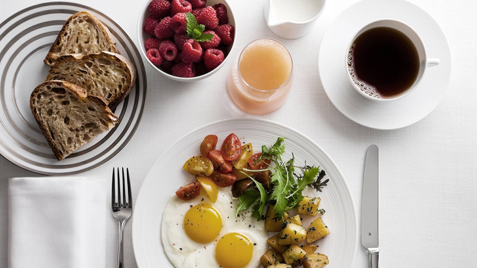 In-bungalow dining breakfast with sunny side egg, roast potatoes and salad, toast, coffee and fresh fruit
