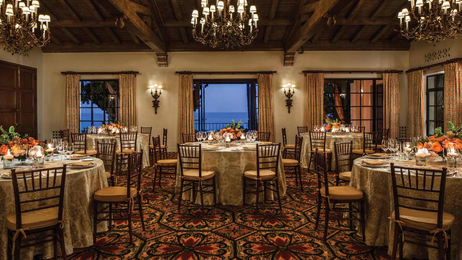 El Mar ballroom with round banquet tables under chandeliers, open patio doors