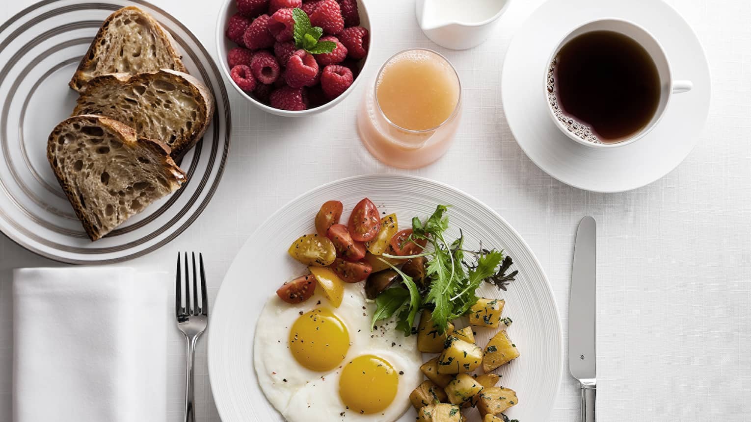 In-bungalow dining breakfast with sunny side egg, roast potatoes and salad, toast, coffee and fresh fruit