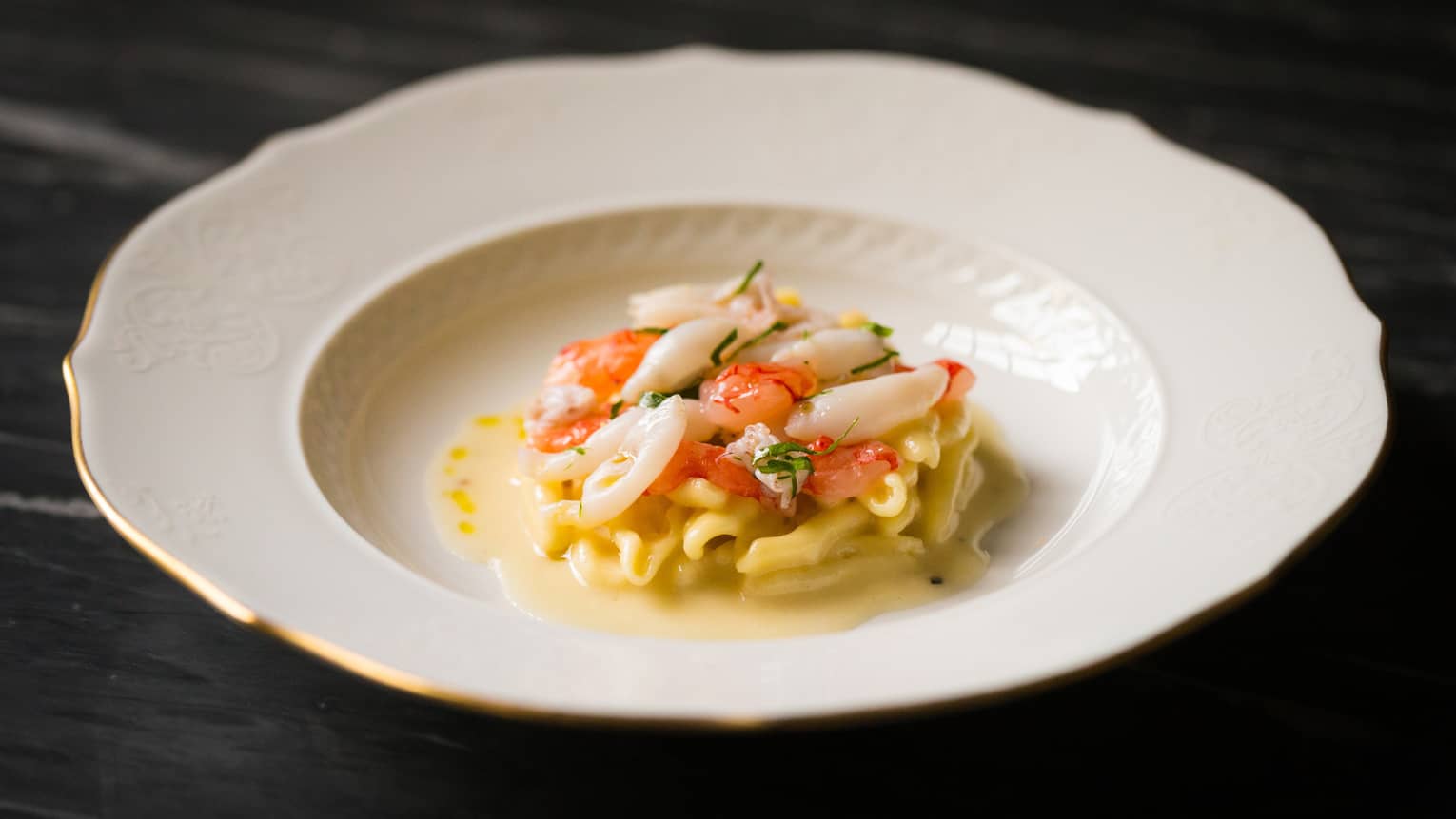 Seafood pasta in white dish