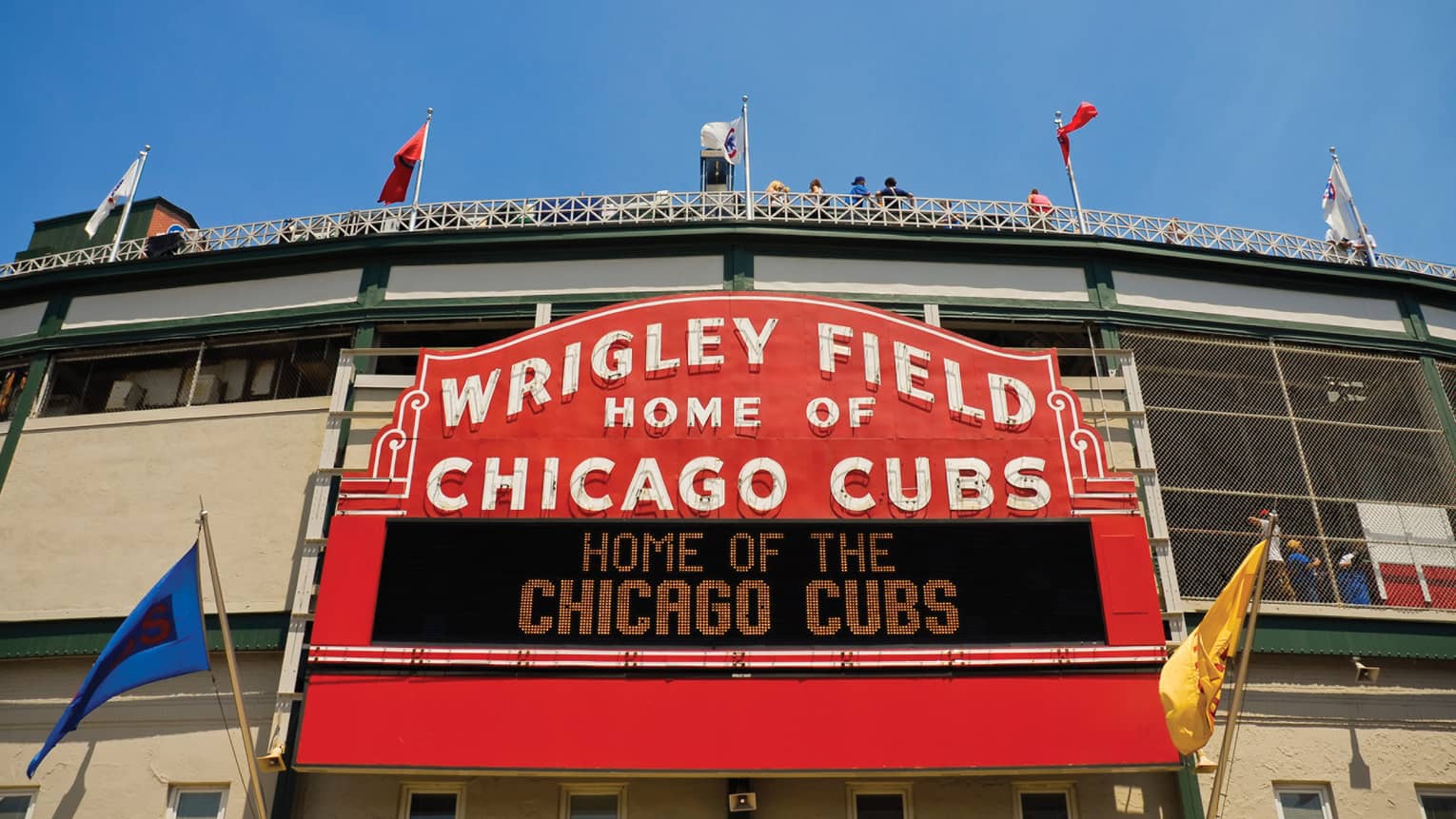 Red stadium sign with name Wrigley Field Home of Chicago Cubs