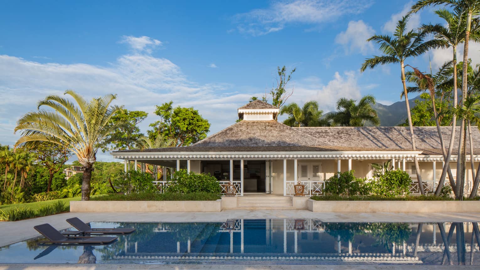 Large, private plunge swimming pool, floating lounge chairs outside Palm Grove Residence Villa