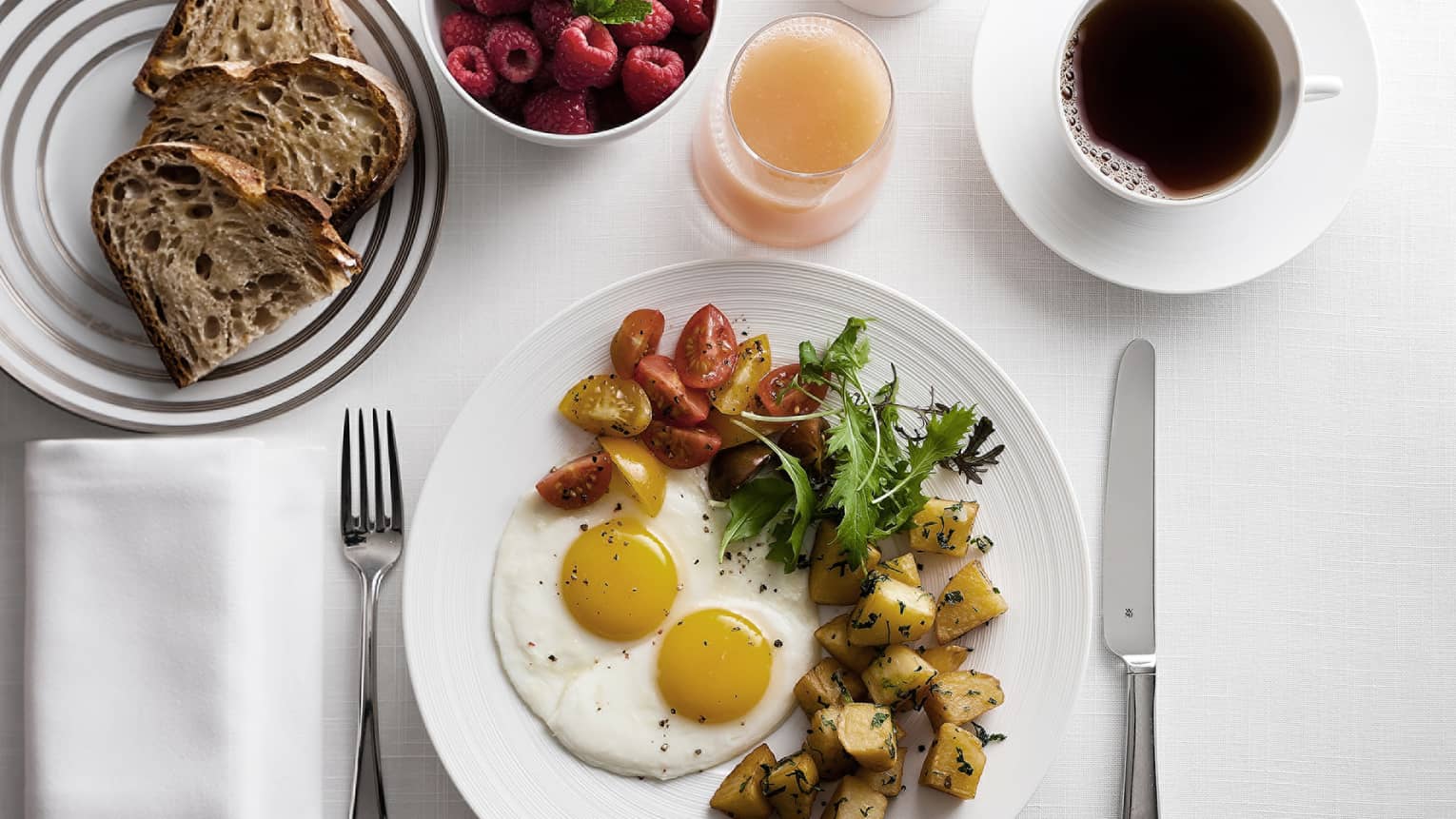 In-bungalow dining breakfast with sunny side egg, roast potatoes and salad, toast, coffee and fresh fruit
