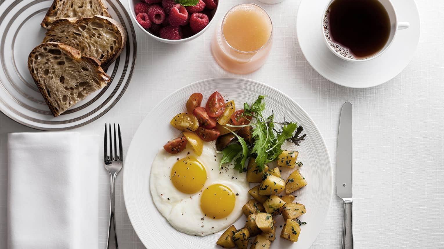 In-bungalow dining breakfast with sunny side egg, roast potatoes and salad, toast, coffee and fresh fruit