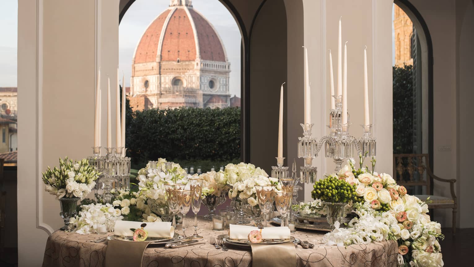White roses, flowers on elegant banquet table under pillows, Duomo views