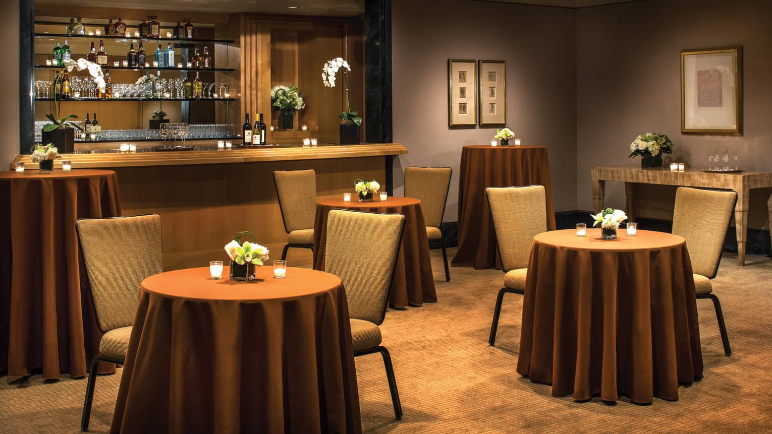 Salon Foyer with small cocktail tables and chairs in front of event bar 