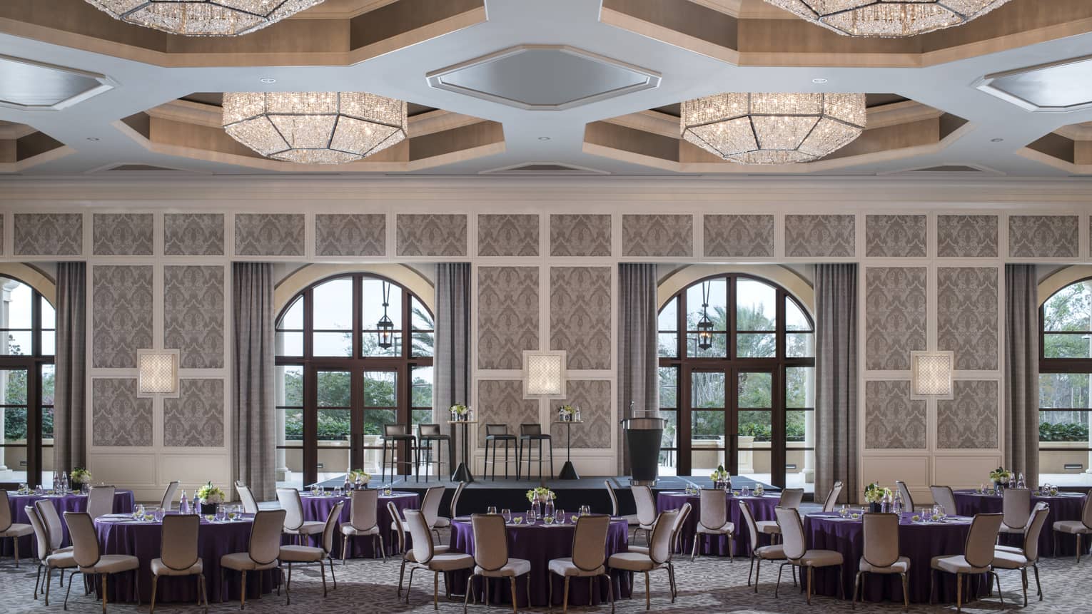 Grand Ballroom with large geometric lights over dining tables, arched windows 