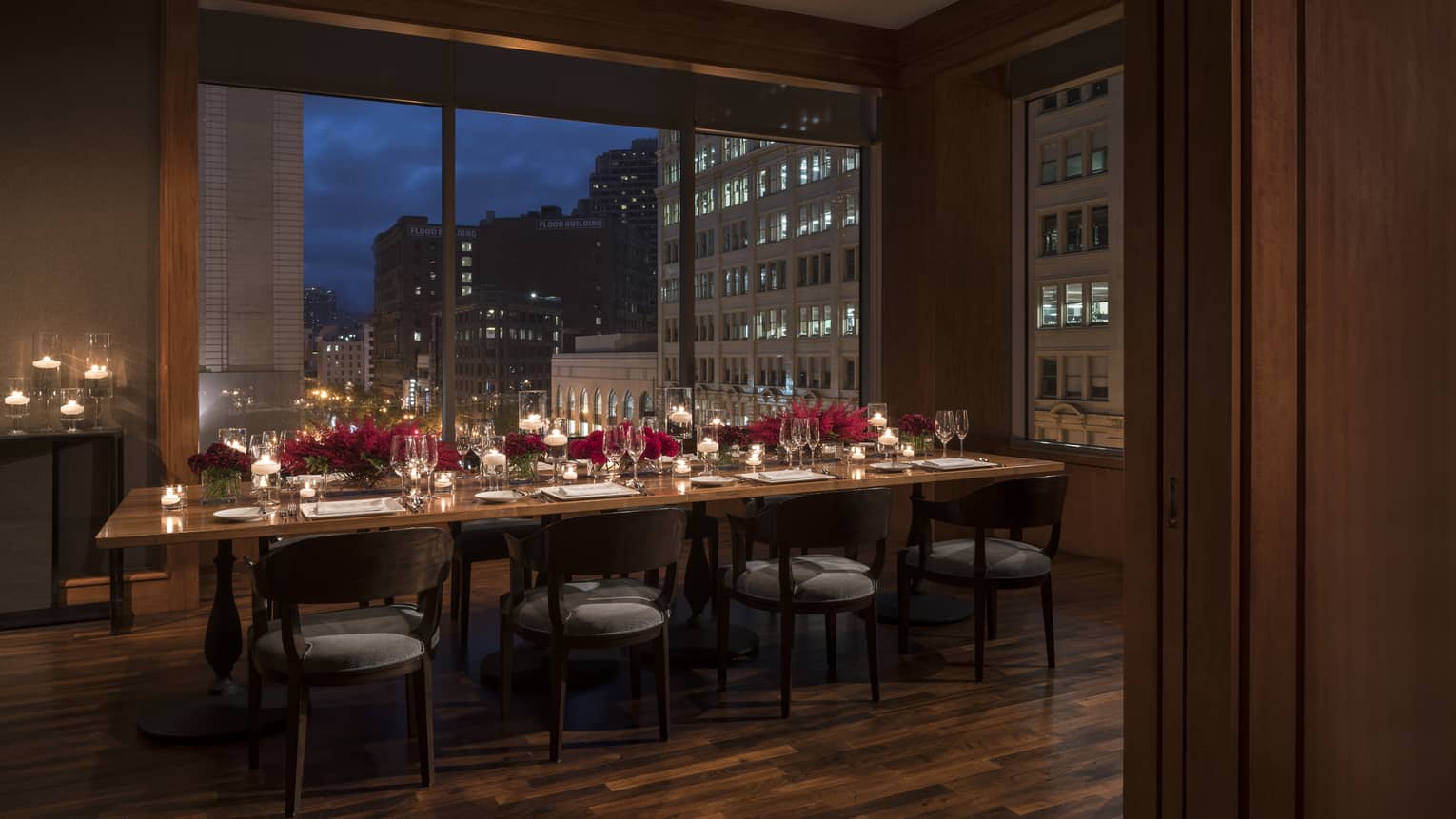MKT Restaurant private dining table with red roses and candles, by window at night