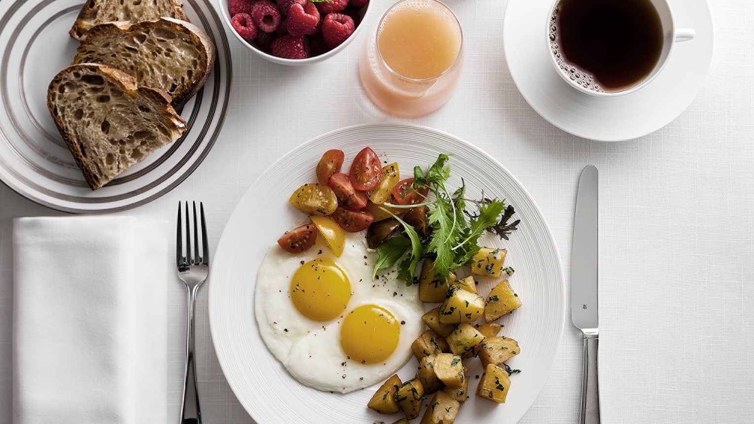 In-bungalow dining breakfast with sunny side egg, roast potatoes and salad, toast, coffee and fresh fruit