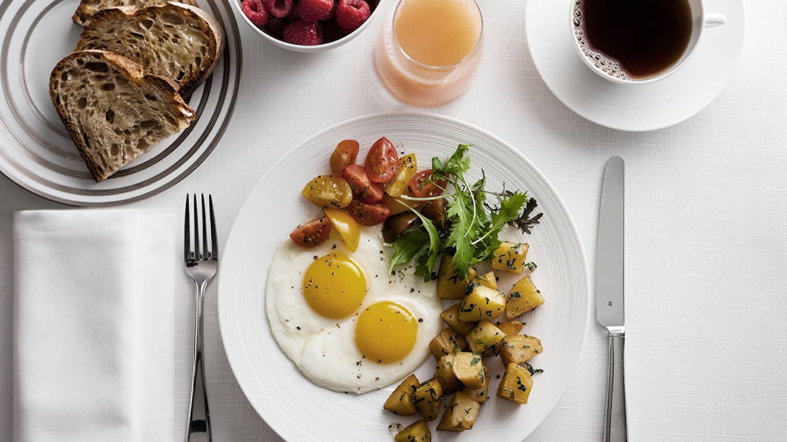 In-bungalow dining breakfast with sunny side egg, roast potatoes and salad, toast, coffee and fresh fruit