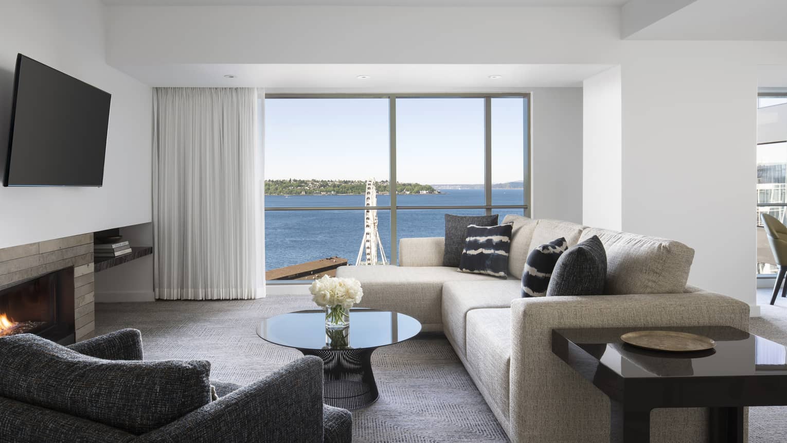 Deluxe Elliot Bay Suite modern seating area by patio door overlooking ocean