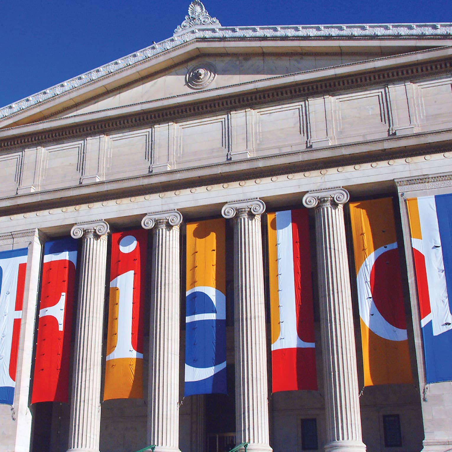Tall white pillars on exterior of the Field Museum of Natural History, against blue sky