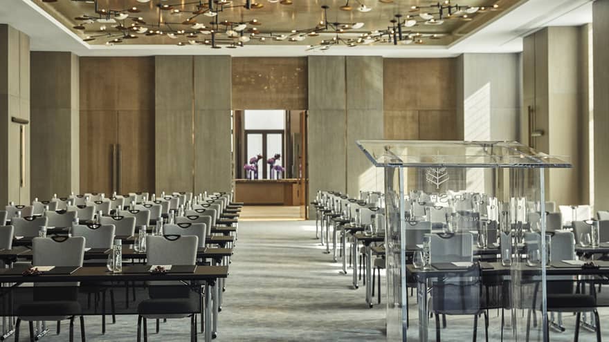 Greenwich Ballroom event space view from glass podium over rows of meeting tables, chairs